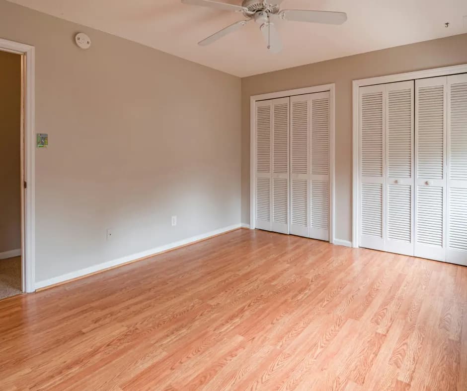 Clean, empty room with pristine hardwood floors after professional junk removal service